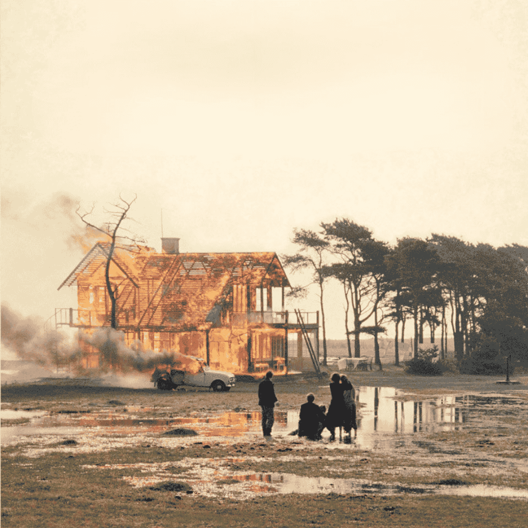 Figures watch a burning house