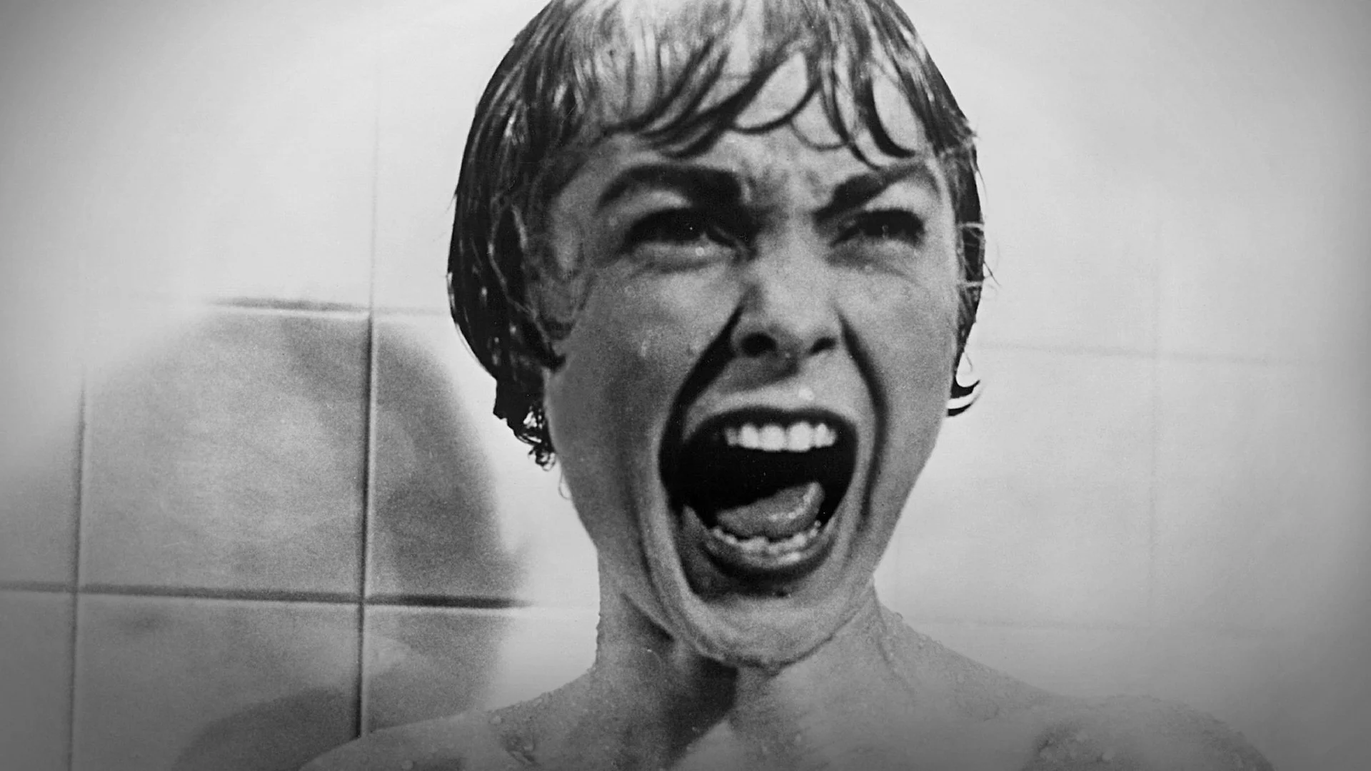 A woman screams in terror in a shower