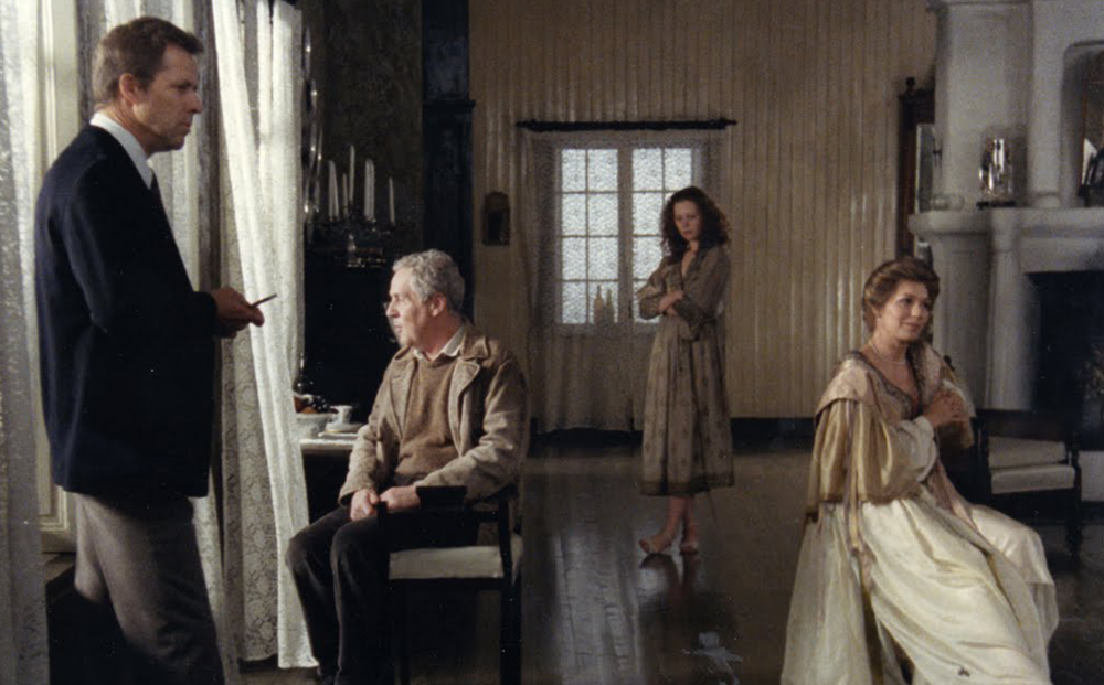 Figures sit around and contemplate in a house