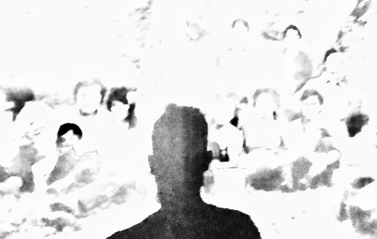 A figure among a shadow of faces