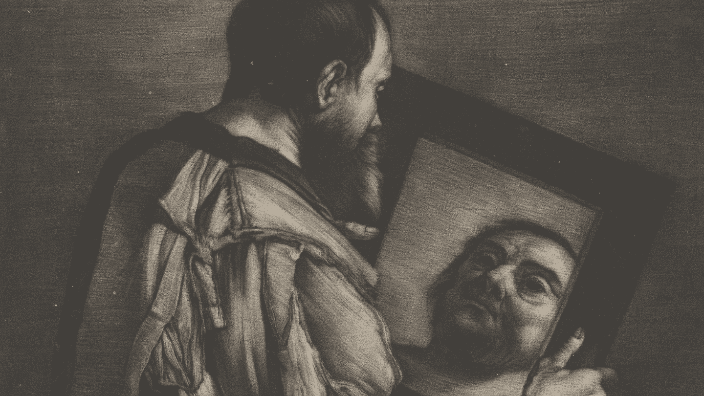 A man looks into a mirror at himself