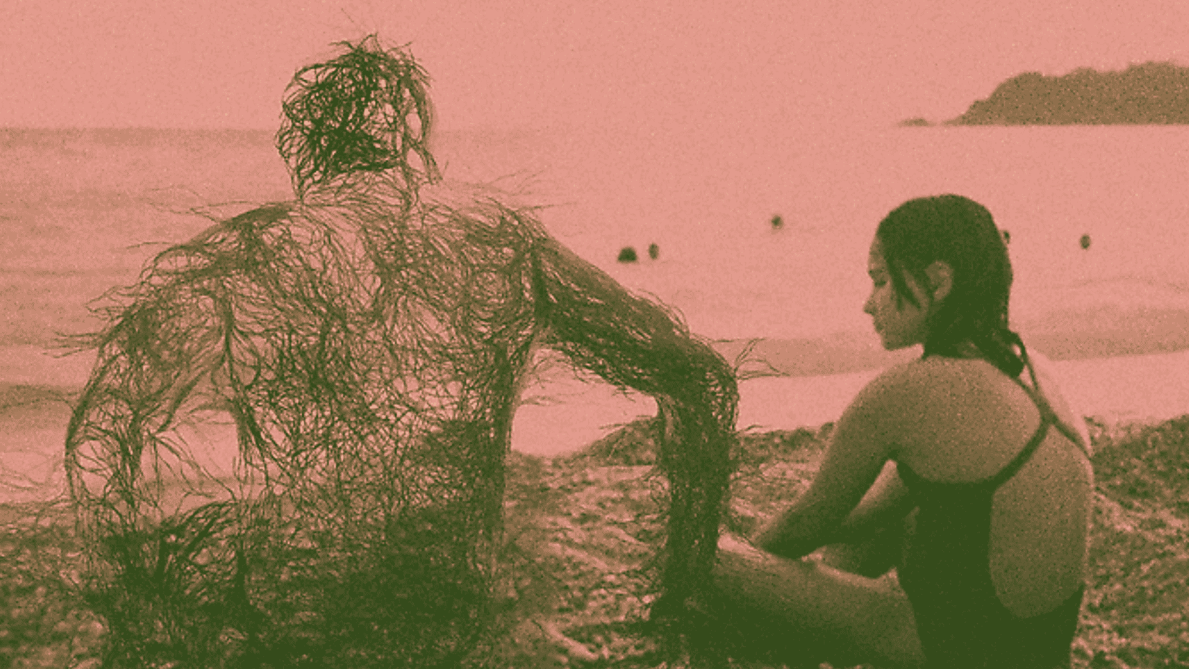 A father and daughter sitting on a beach