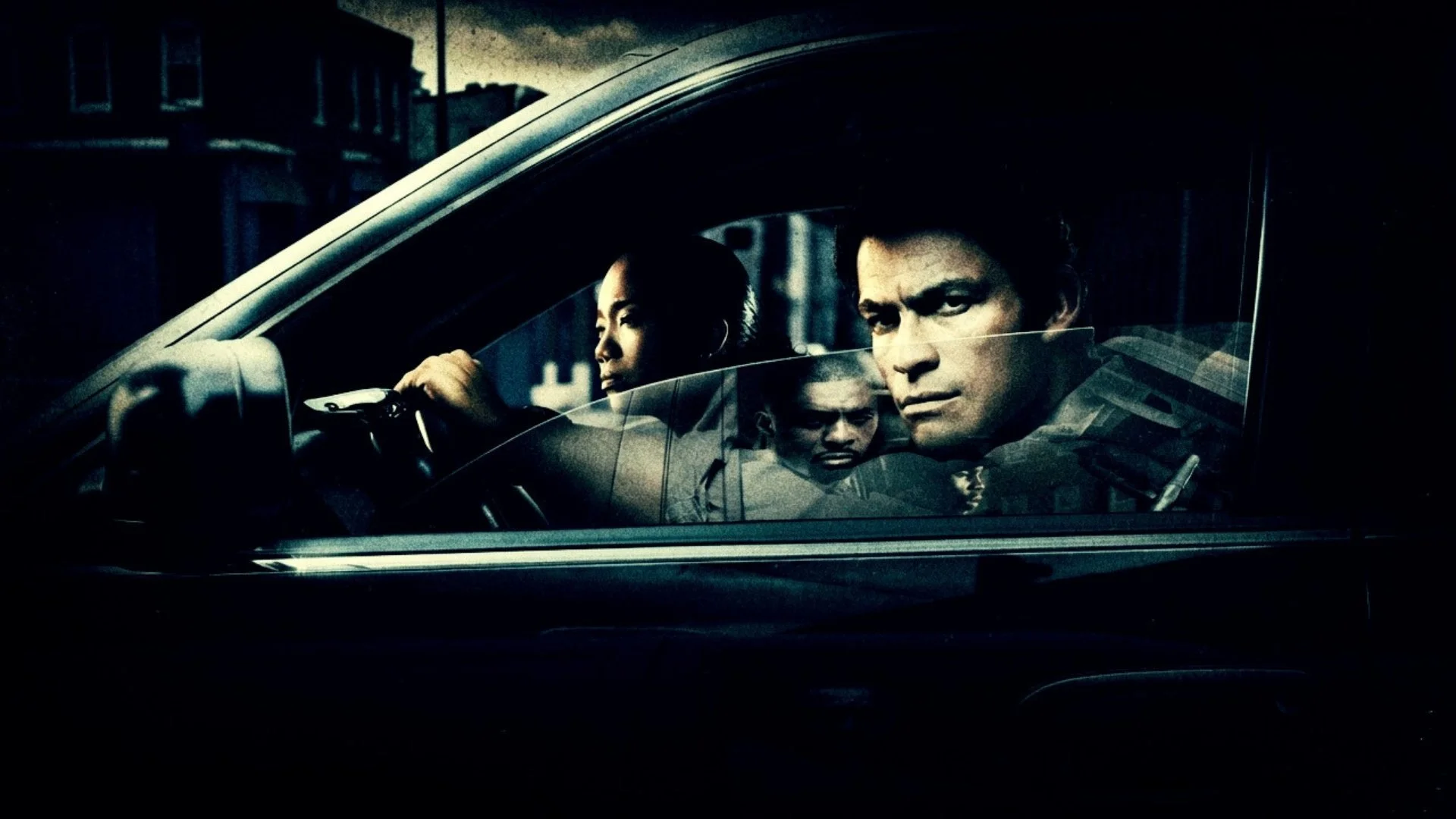 Two police officers look our of a cop car with menace