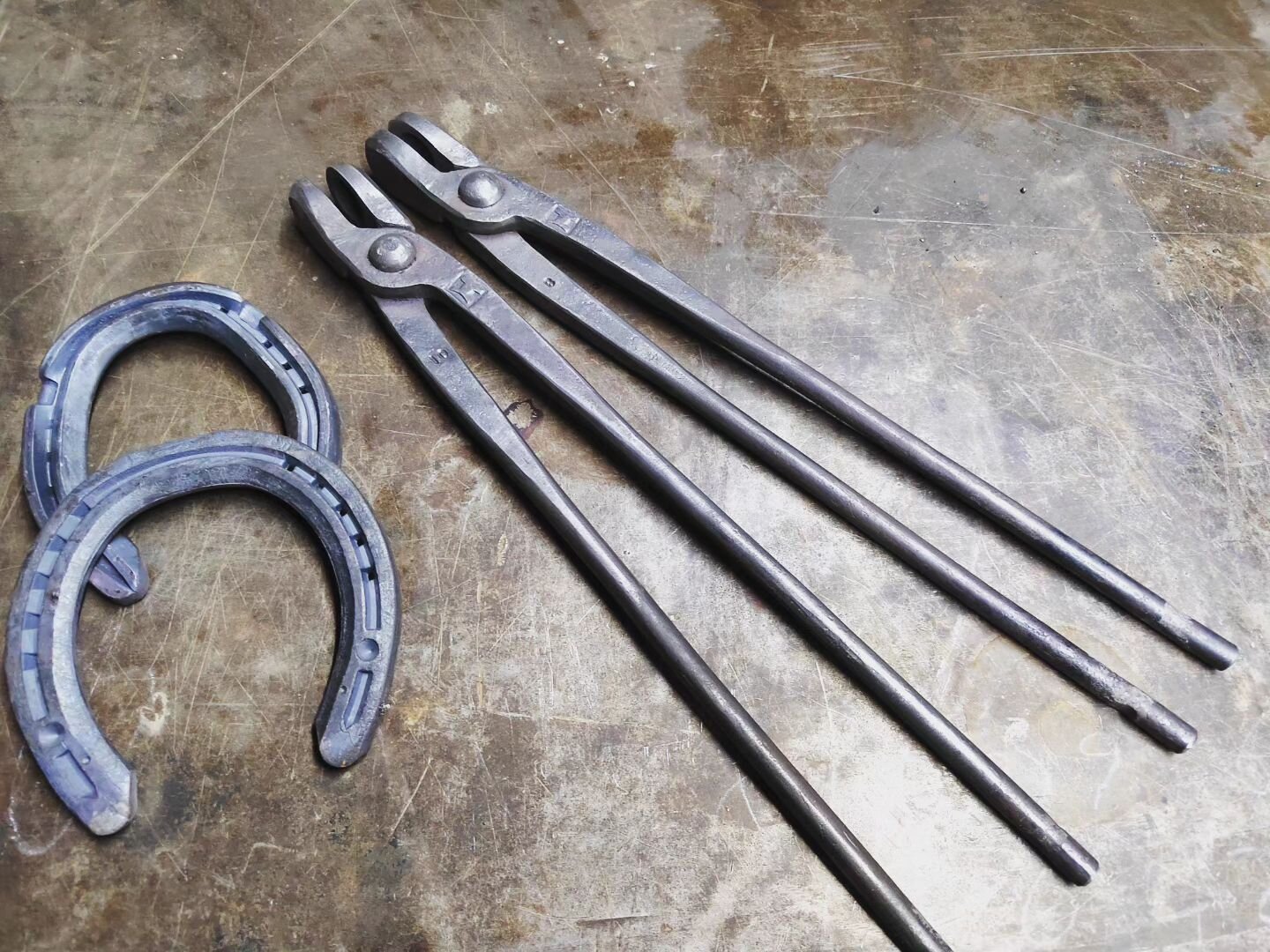 Couple of lovely pairs of farrier's tongs in the traditional style  sized for 3/8 &quot; and 5/16&quot; (or 10 and 8mm in new money).
Made from a medium carbon tool steel for a little added toughness at the customer's request.
Down here at the forge 