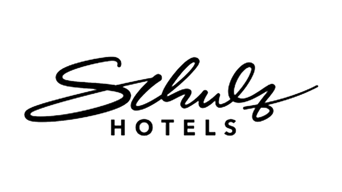 The image features the logo of Shula's Hotels, with the word "Schulz" written in a stylized, cursive font and "HOTELS" in uppercase, sans-serif font underneath. - Commercial Client of Kantara Productions
