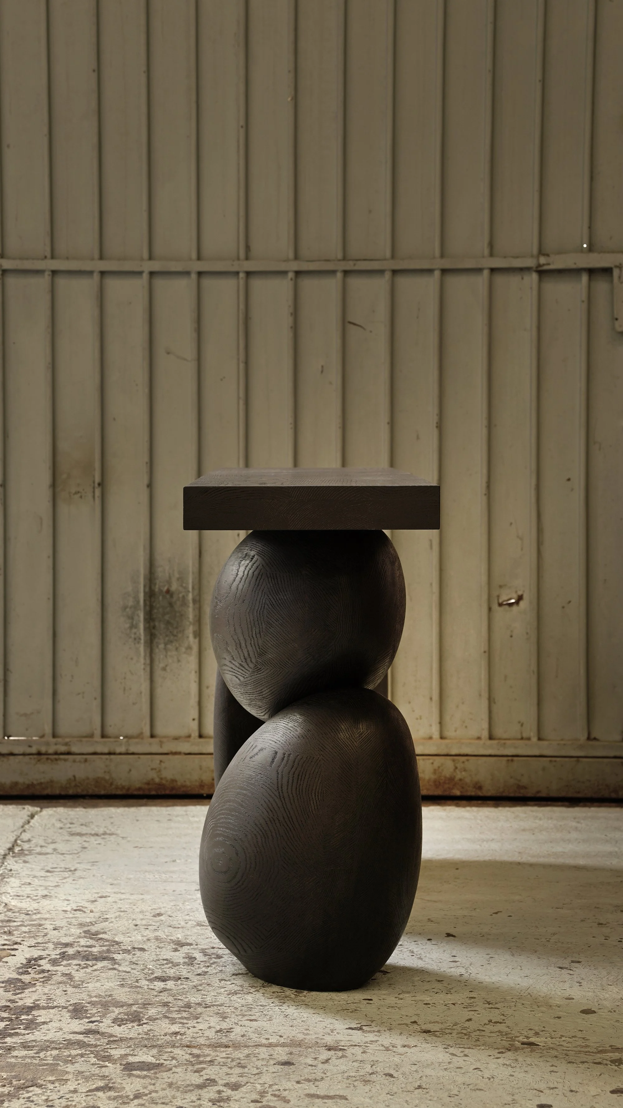 Elefante entry table with rounded oak bases and a thin minimalist top.