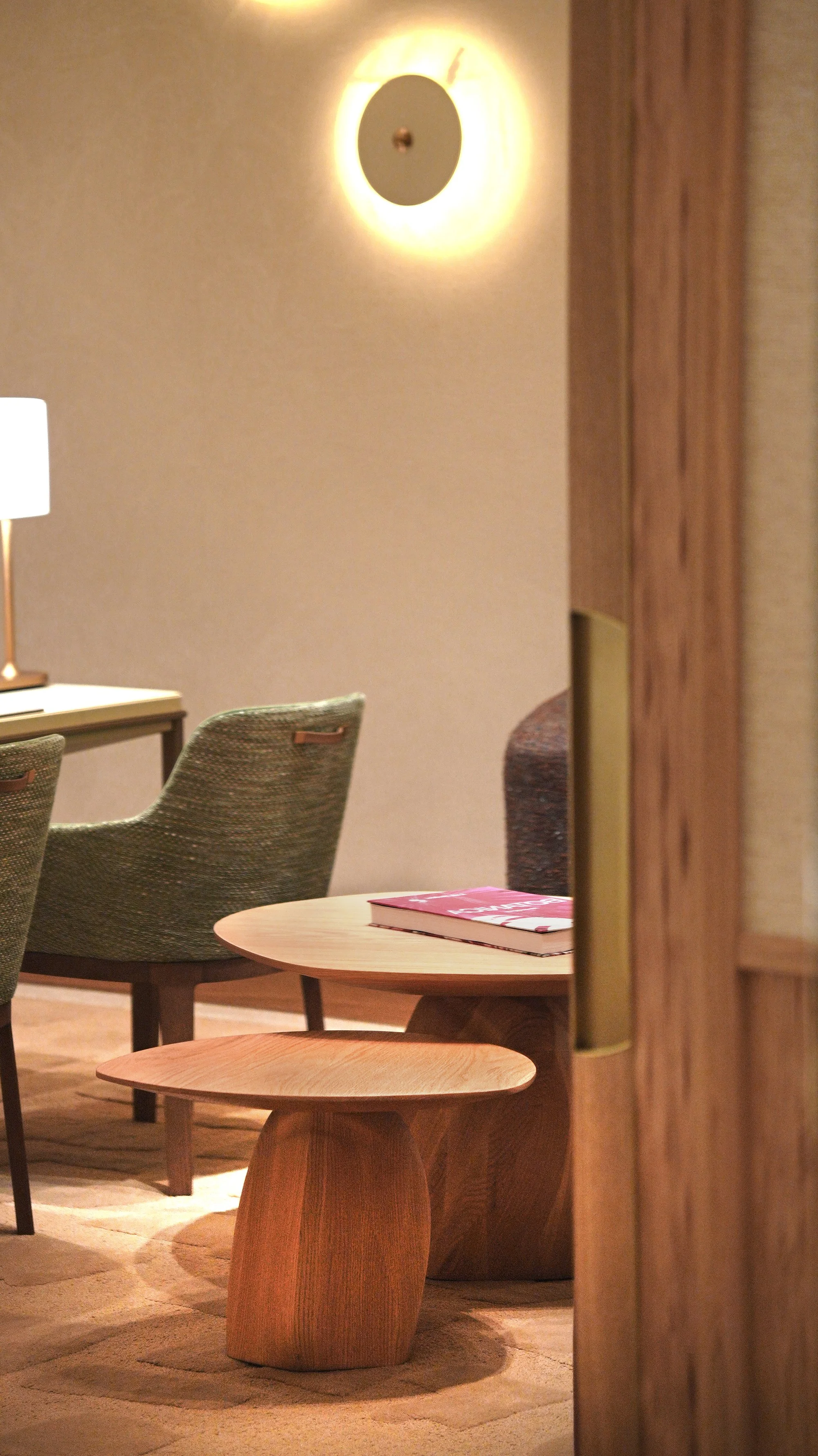 Paired Solace tables forming a coffee table, faceted wood bases with fluid tops.