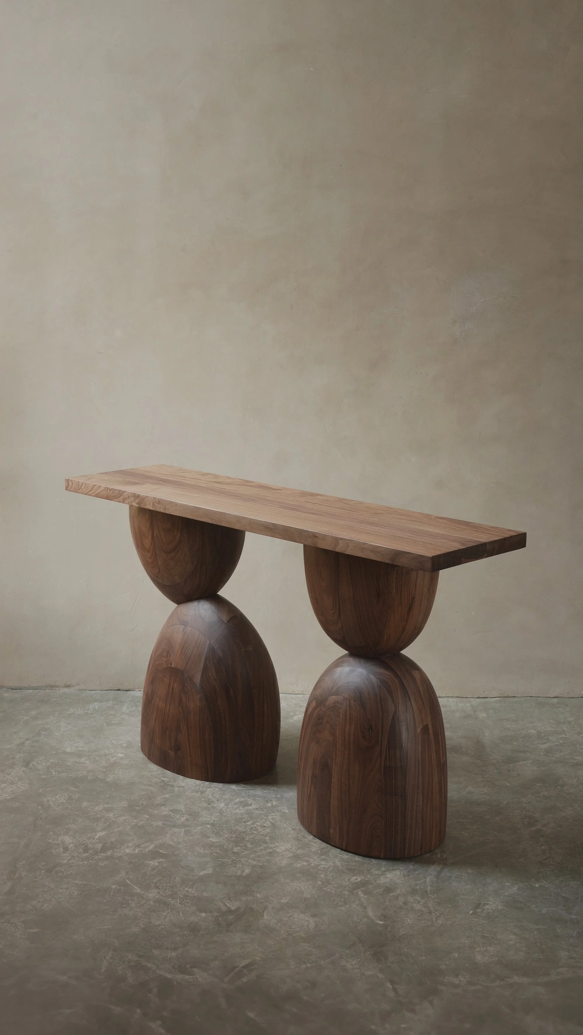 Elefante console table with stacked, asymmetrical walnut volumes.