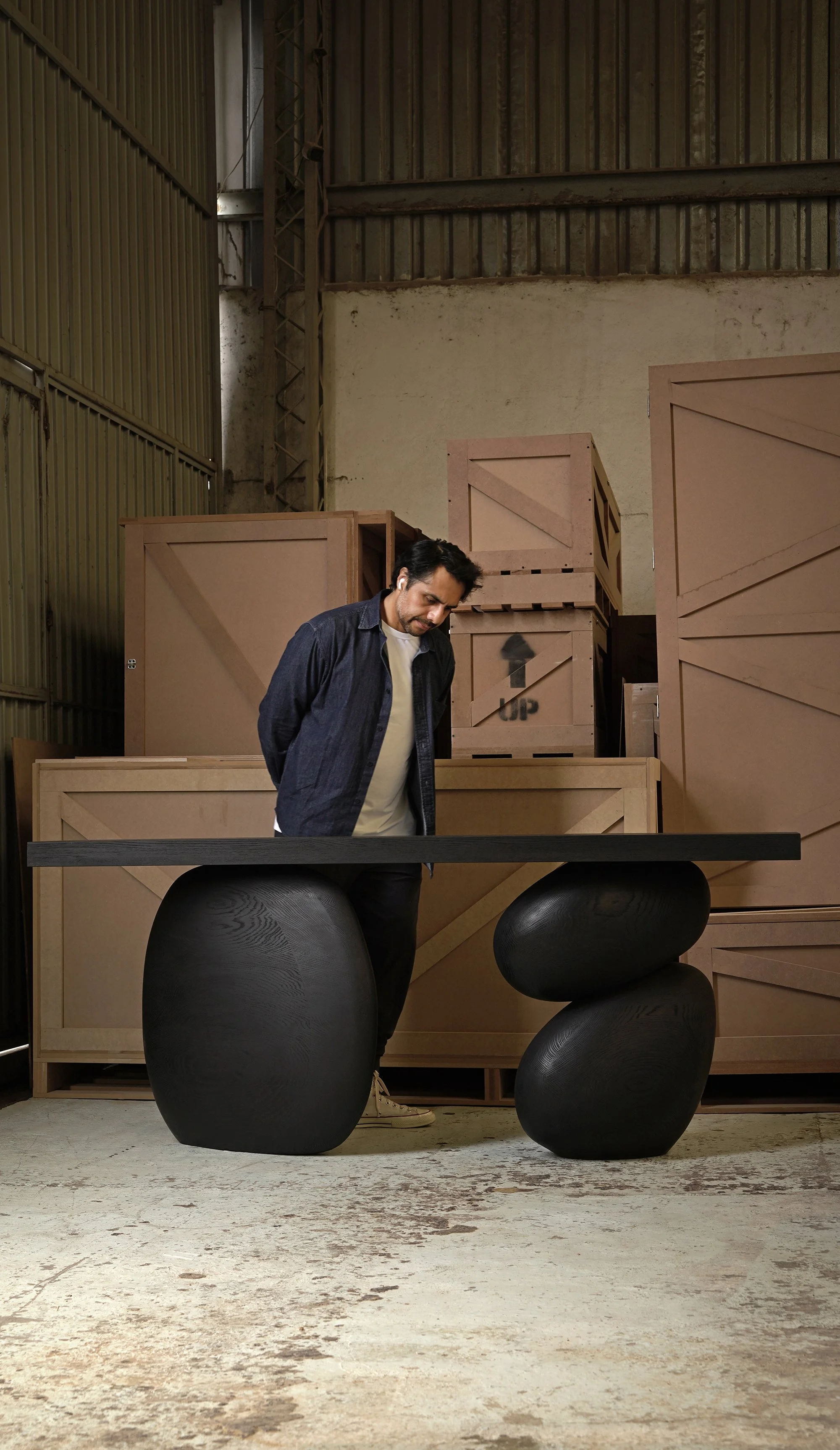 Elefante entry table with rounded oak bases and a thin minimalist top.