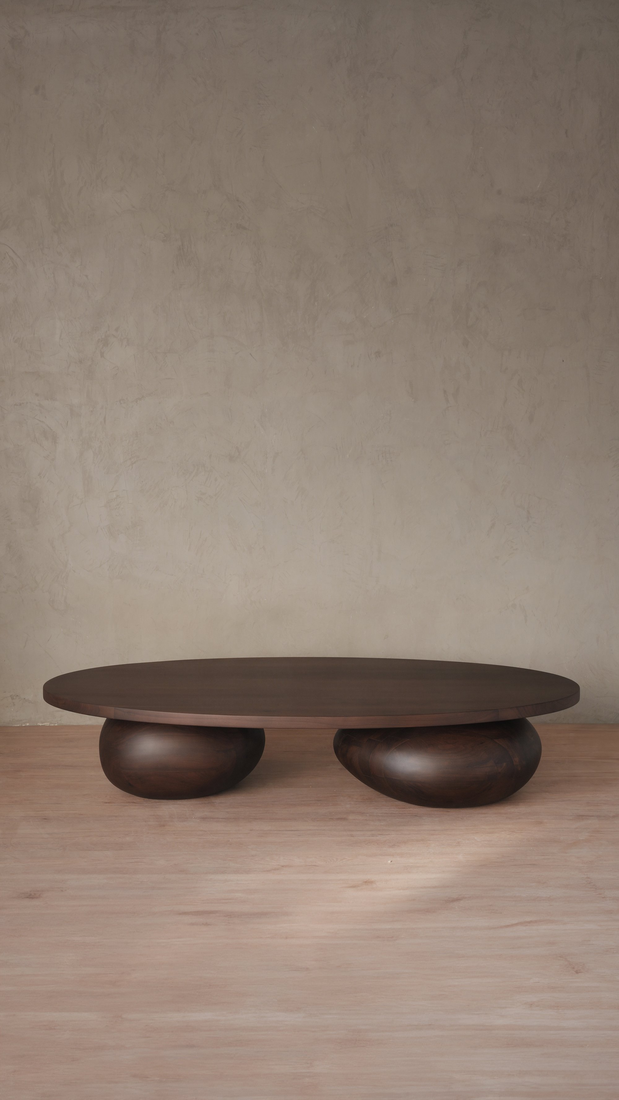 Walnut Sereno coffee table with massive sculptural legs that lift the top, creating a floating effect.