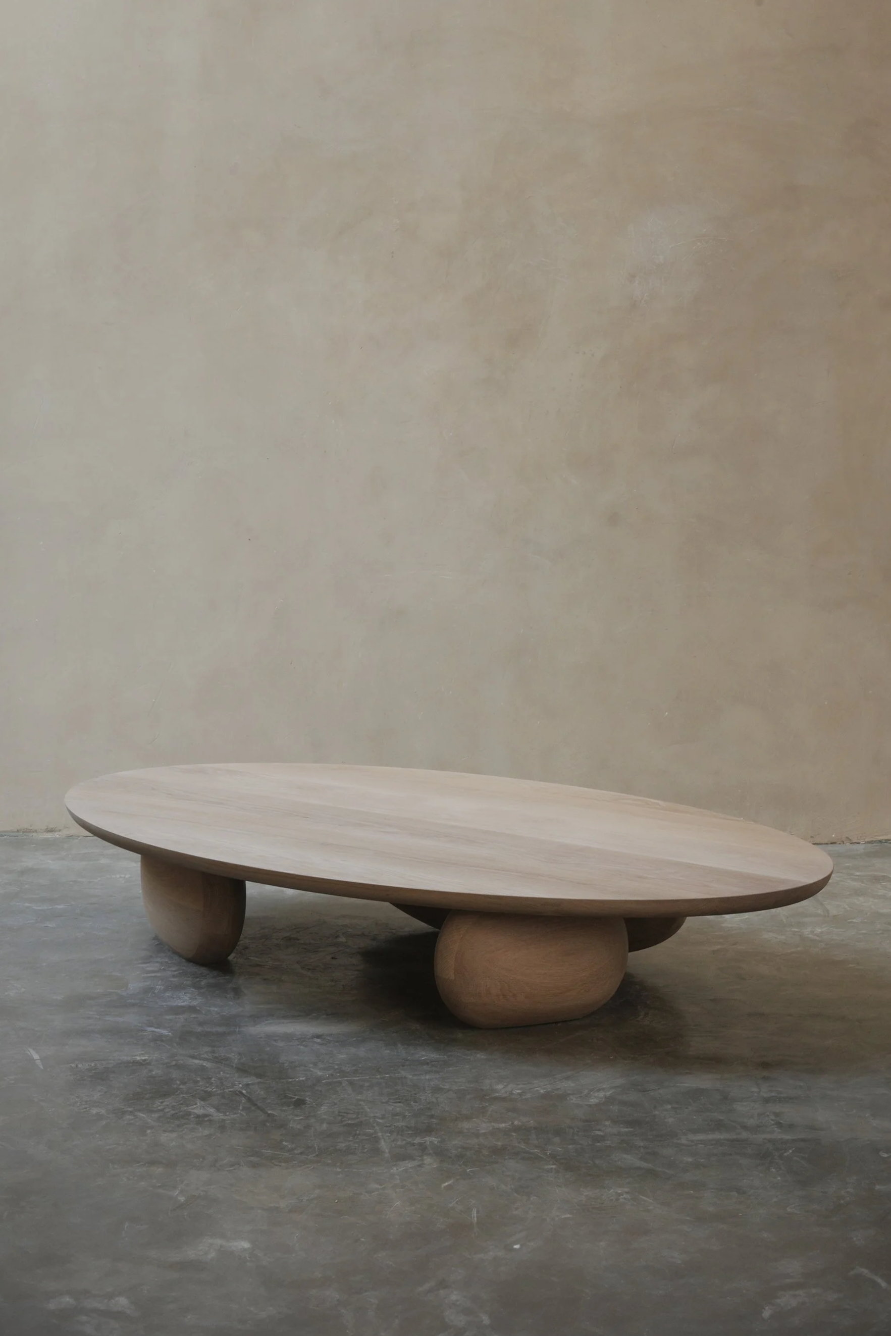 Fishes coffee table with asymmetrical sculptural legs and softly rounded top.