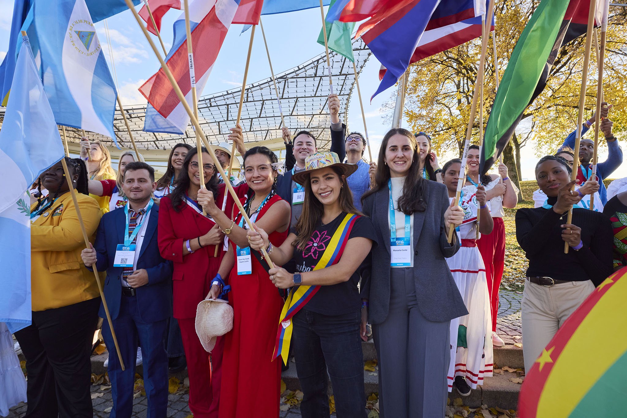 Corporate event with young people holding flags at opening ceremony and international conference