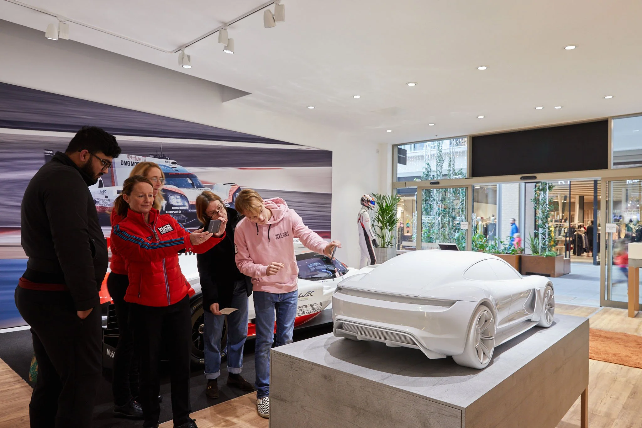 Porsche store shoppers get a demo on a VR model with interactive model in the store 