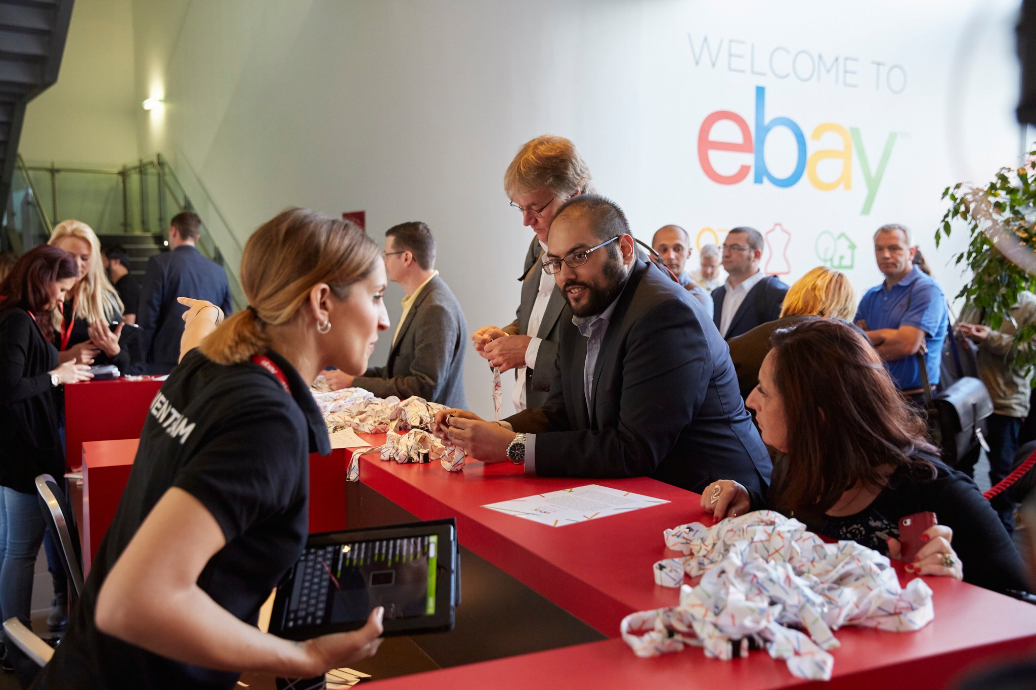 Man at registration at eBay event in Manchester smiling at host