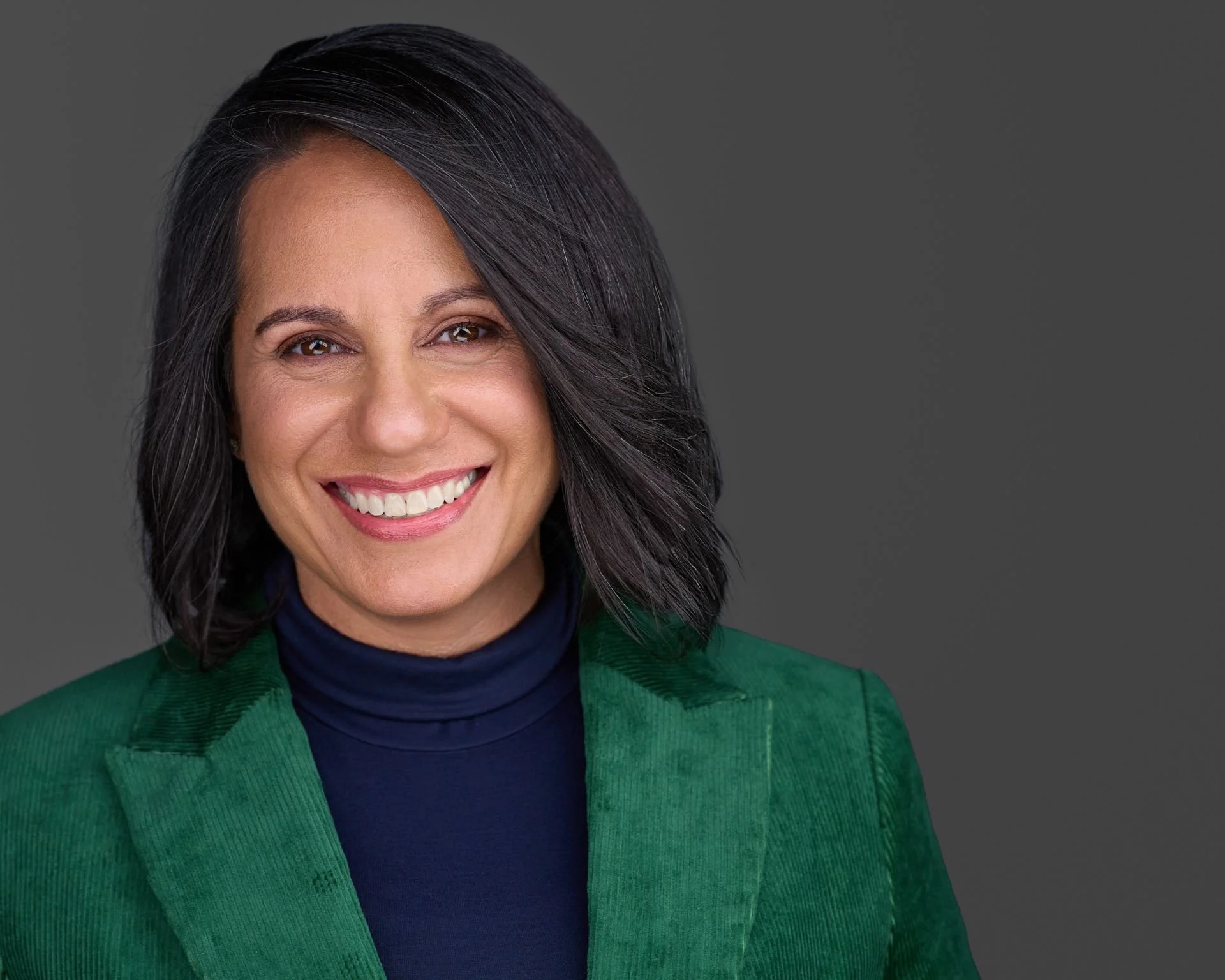 Smiling African-American Woman Executive in Green Jacket