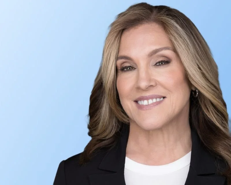 Executive woman with long blonde hair looking very confident.