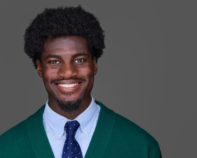 Young African-American Professional Dressed in a shirt, tie and sweater