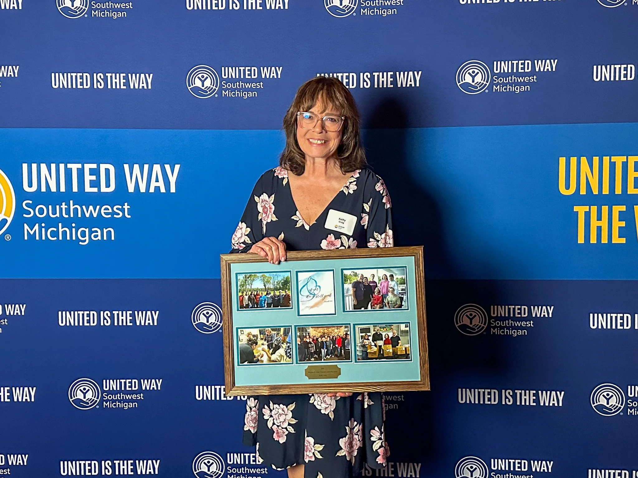 Kathy Craig holds a framed photo collage at United Way of Southwest Michigan’s Annual Celebration, where she received the Margaret B. Upton Volunteer Leadership Award.