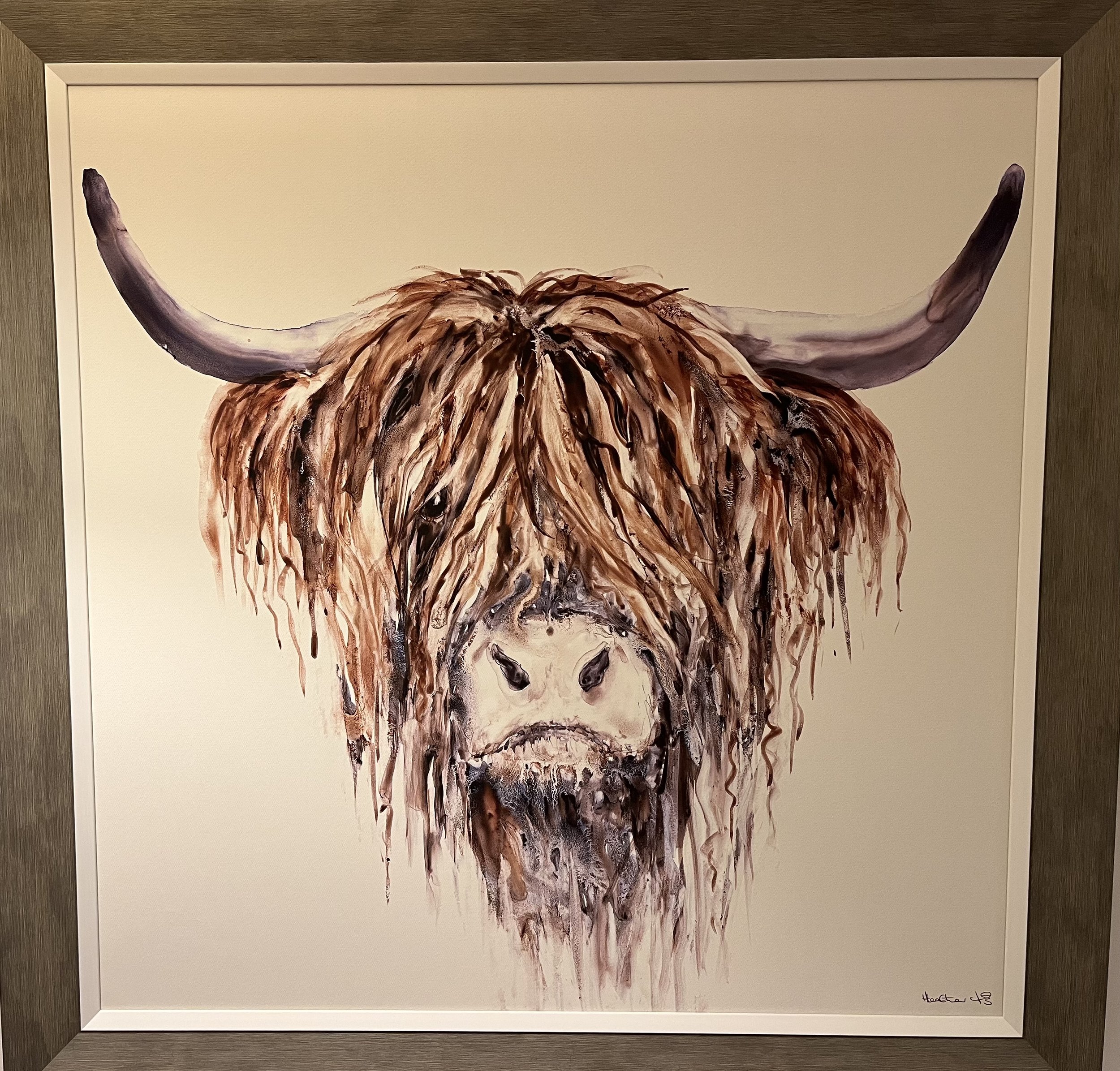 Painting of a Highland cow with long, shaggy reddish-brown hair covering its face, large curved horns extending outward – rustic Scottish decor detail at Aviemore holiday home.