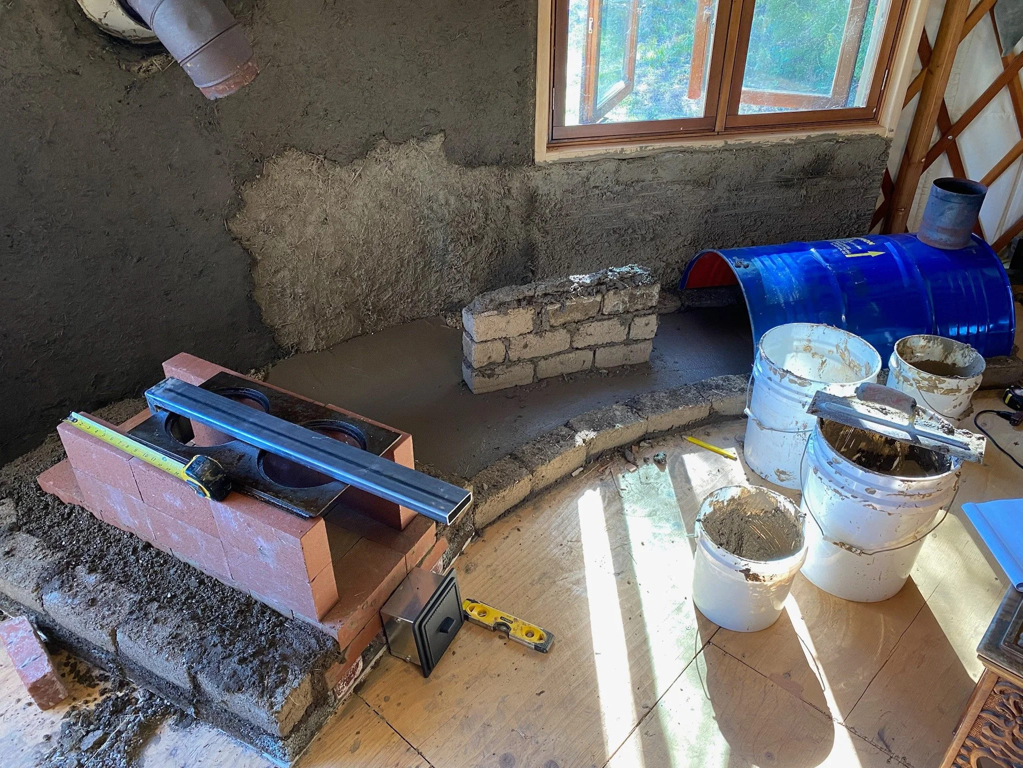 This image shows the beginning of the fire box, and the inside of what will become the bench.  Barrel creates a 'bell'.