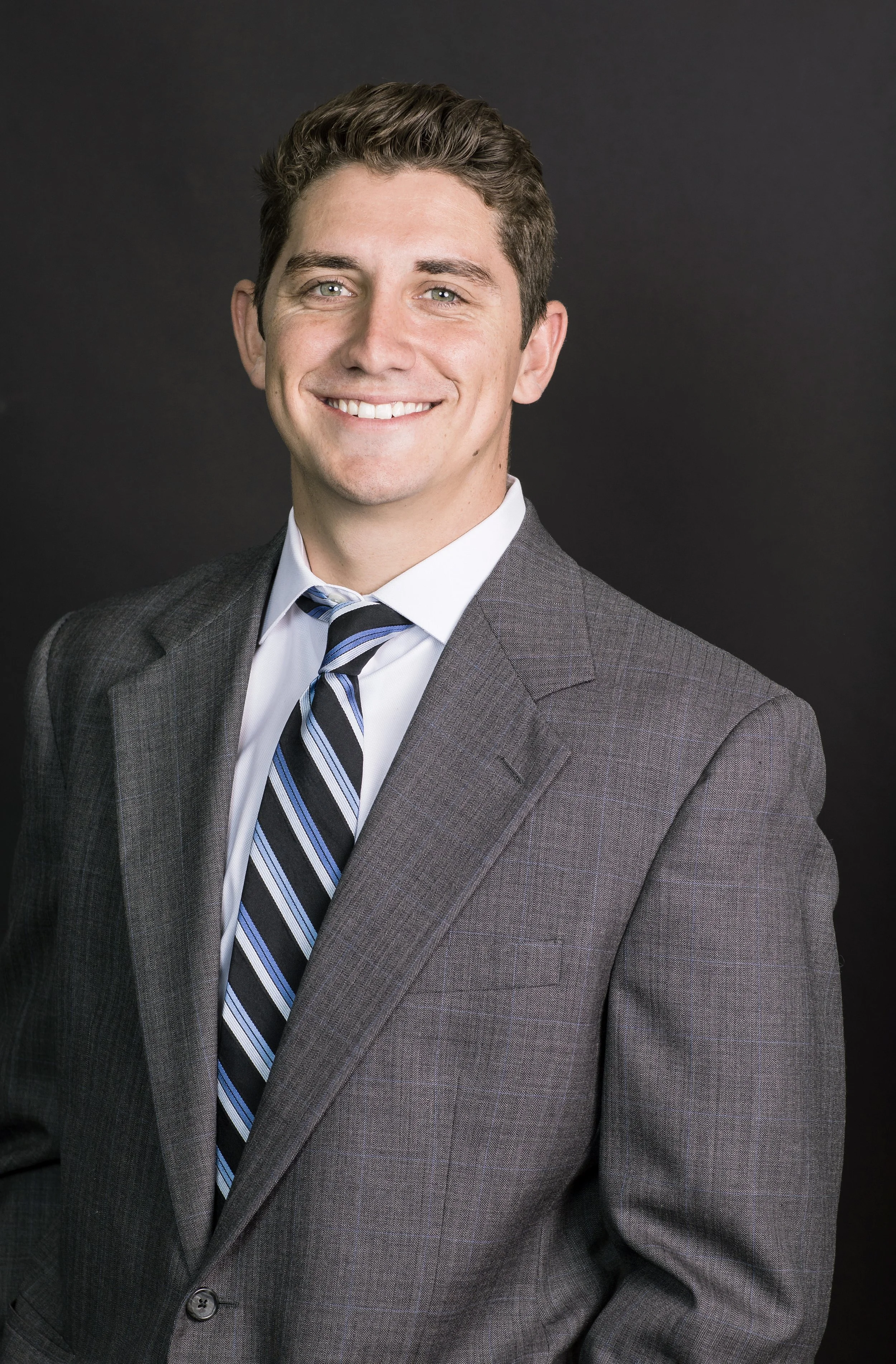 Young executive headshot in studio