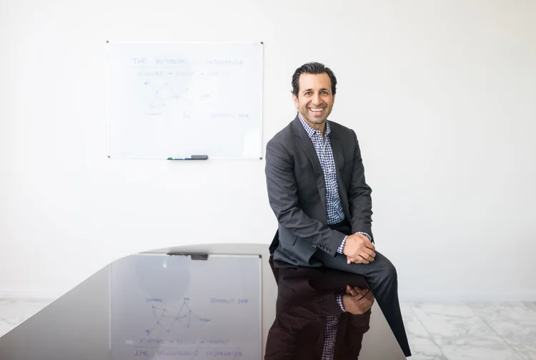 Software company CEO photographed in a relaxed pose in a New York boardroom