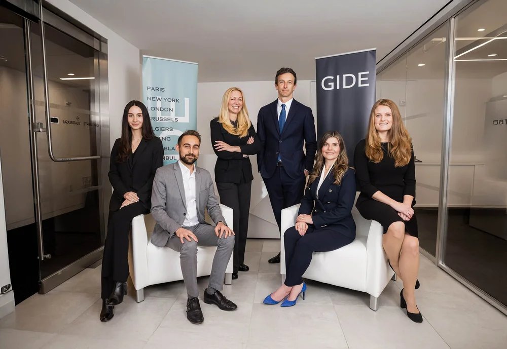 Law firm team portrait of six attorneys in business attire in a modern New York office