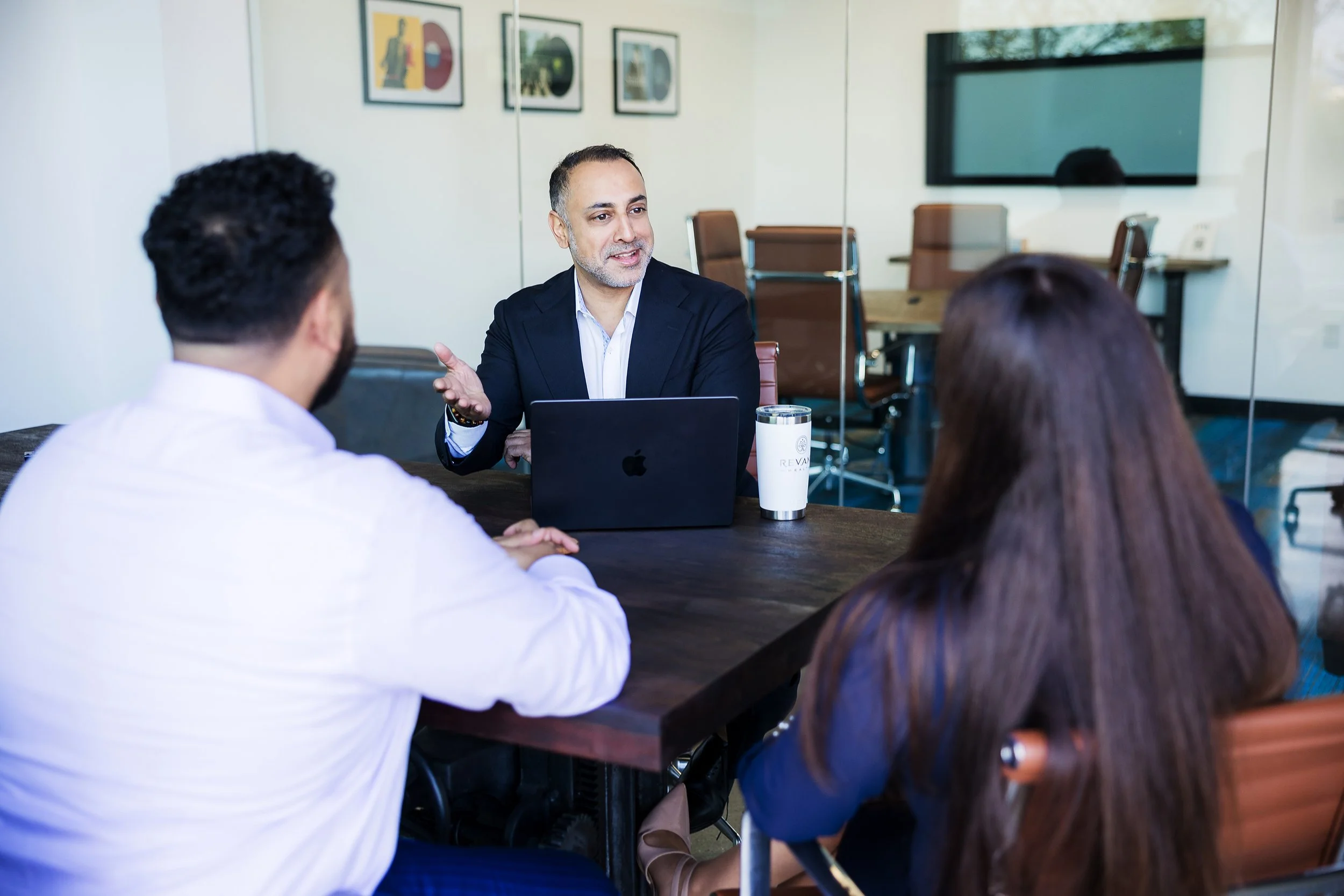 Wealth management professional meeting with potential clients in their conference room