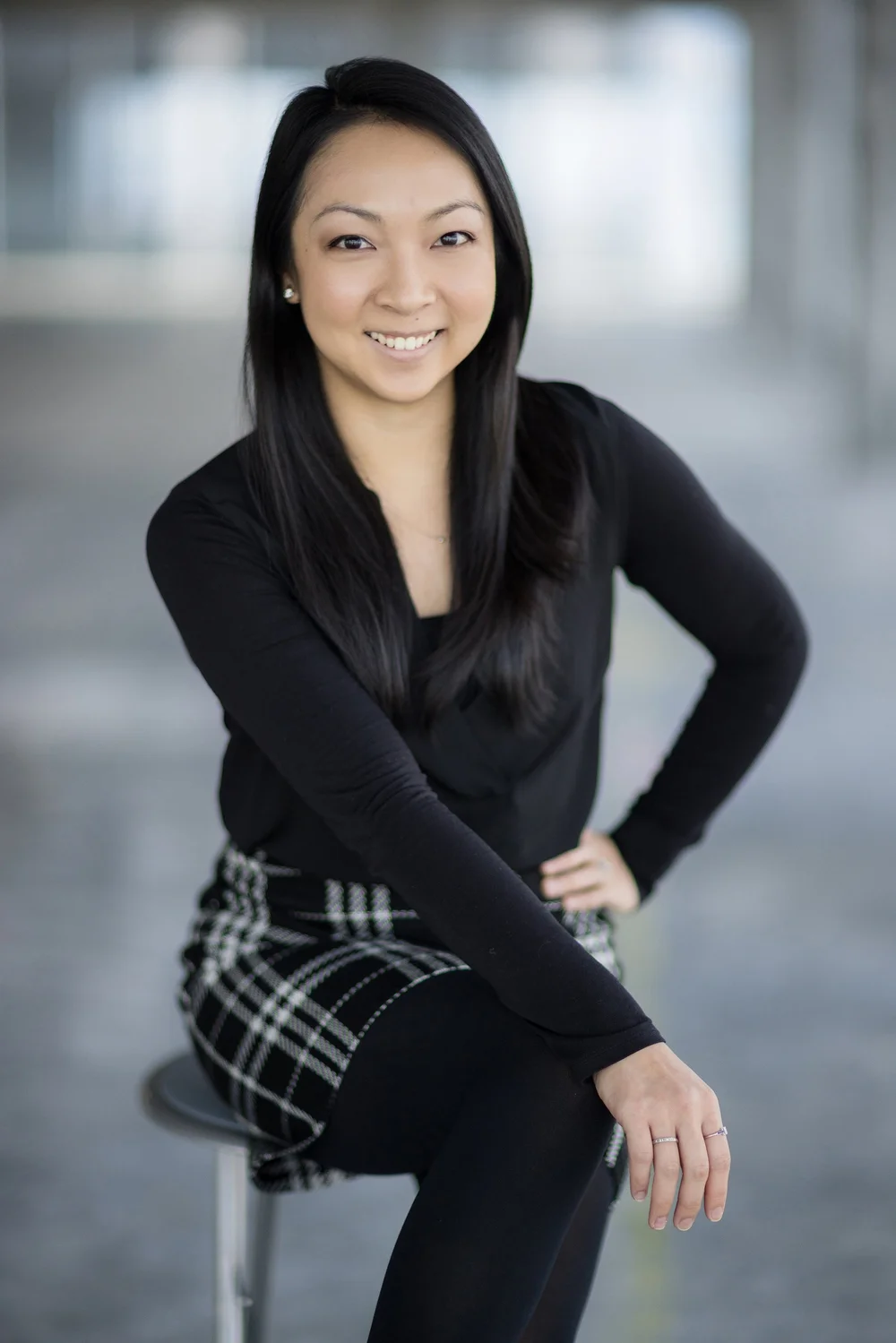Environmental business portrait of a woman seated in a bright modern office