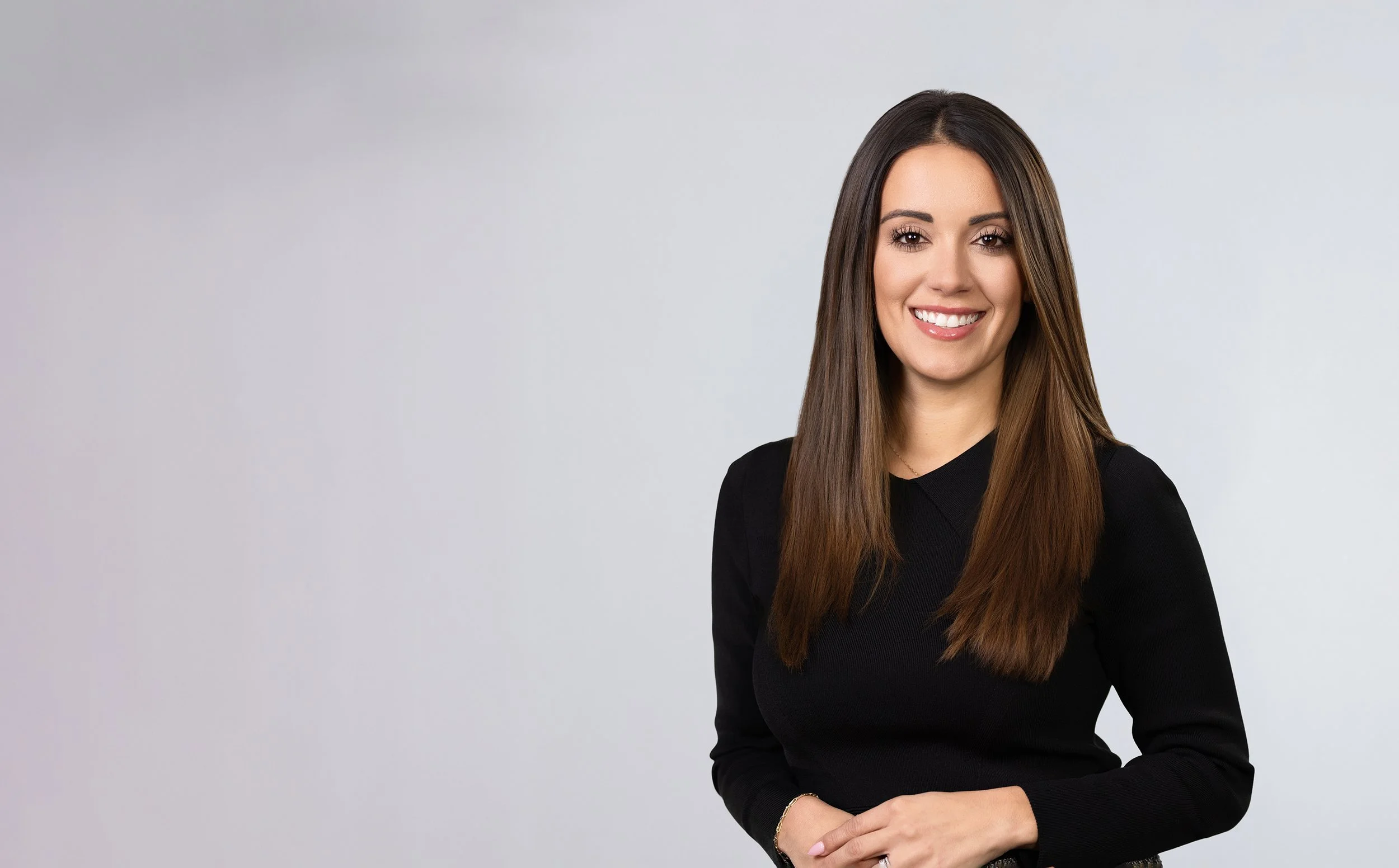 Corporate headshot of a New York City professional woman in a black blazer, photographed by Blue Sky's Studio