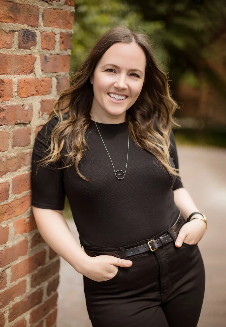 Casual professional headshot of a young executive in DUMBO, Brooklyn