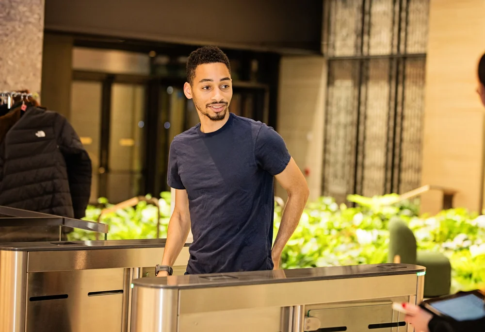 Front desk team member welcoming a guest in a boutique hotel lobby