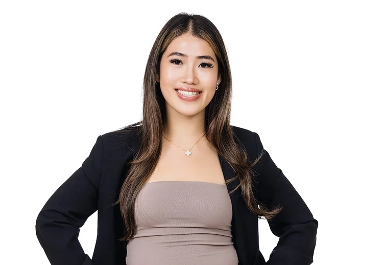 NYC team headshot of a woman in a black blazer on a white background