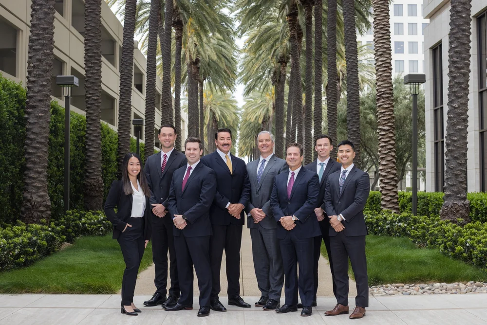 Group corporate photography of eight business professionals on a city sidewalk
