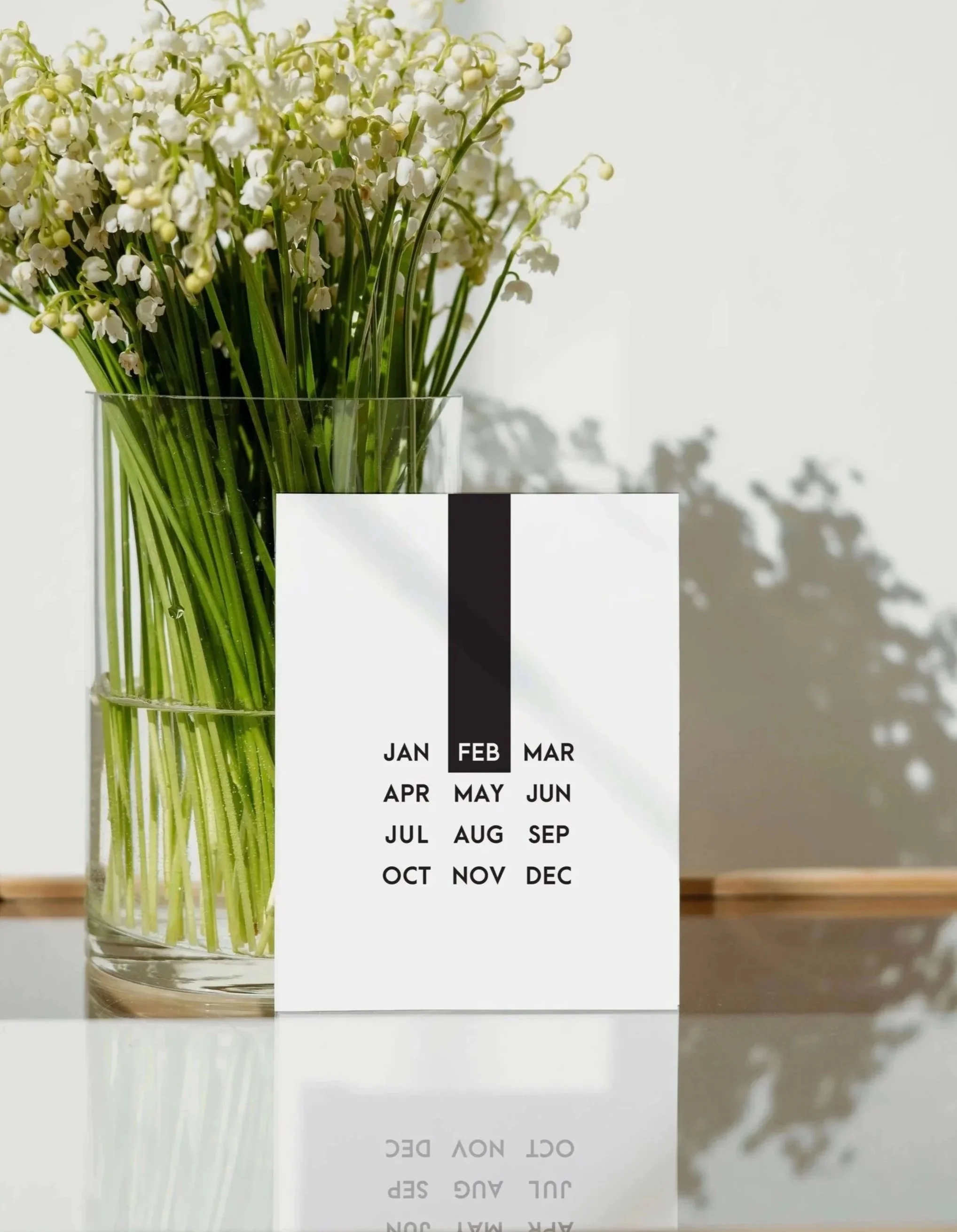 Black history greeting card, on glass table with a vase of white flowers