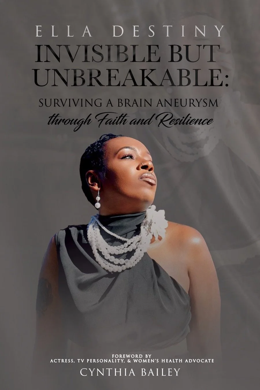 Book cover titled "Ella Destiny: Invisible but Unbreakable: Surviving a Brain Aneurysm through Faith and Resilience" featuring a woman with short black hair, wearing pearl jewelry and a black dress, looking upward.