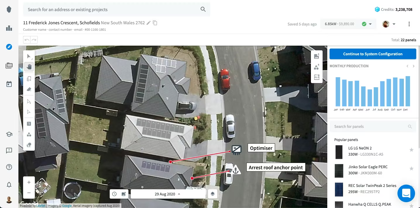 Aerial view of a neighborhood street with houses, cars parked along the curb, and yards. The image includes annotations indicating an optimizer and an arrest roof anchor point on one house.