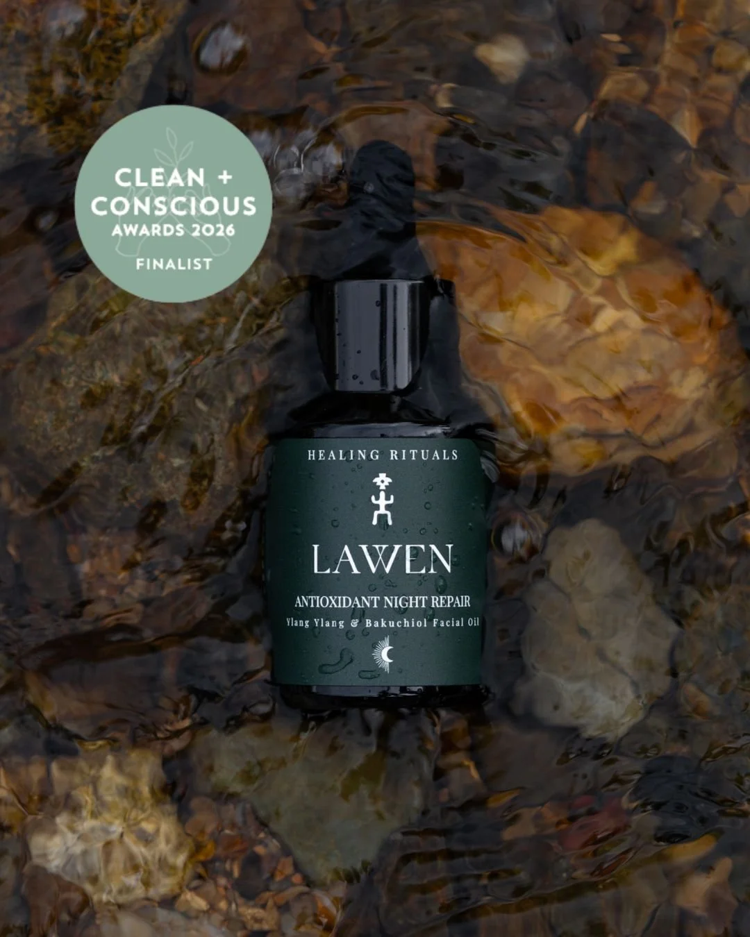 Lawen Antioxidant Night Repair Serum, Clean + Conscious Awards 2026 finalist, botanical facial oil photographed in a flowing natural stream.