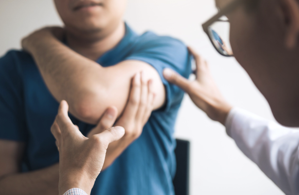 Doctor administering a vaccine injection to a man's upper arm.