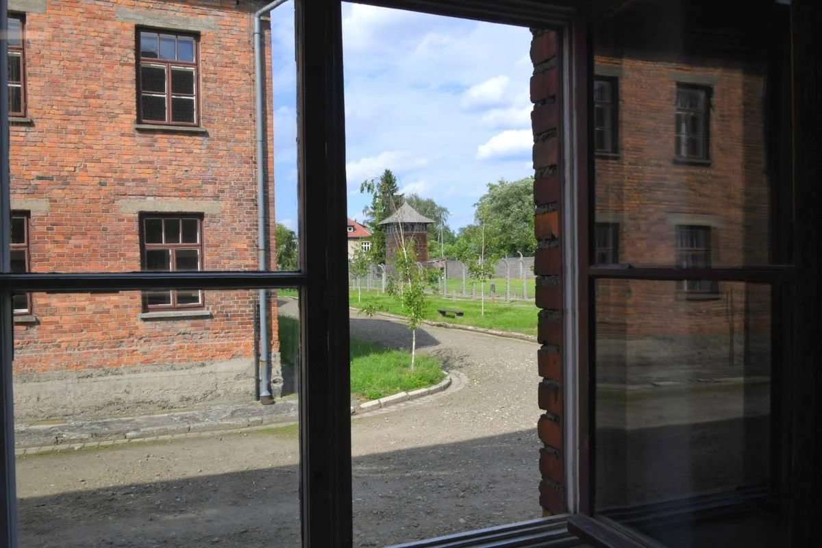 MAC_5484 · Camp road and fence through an open window, Auschwitz I, Poland