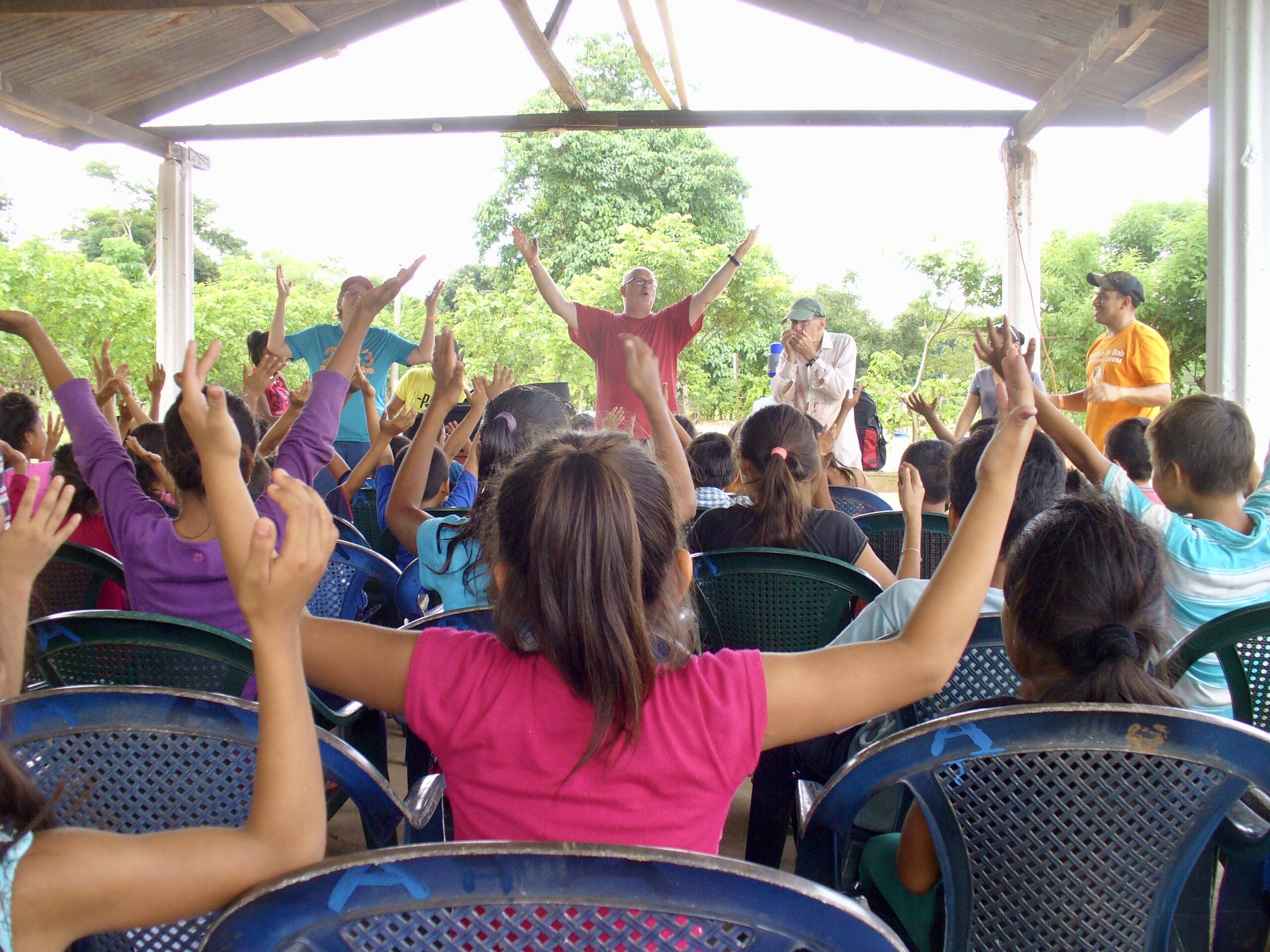 Kids with arms raised in worship