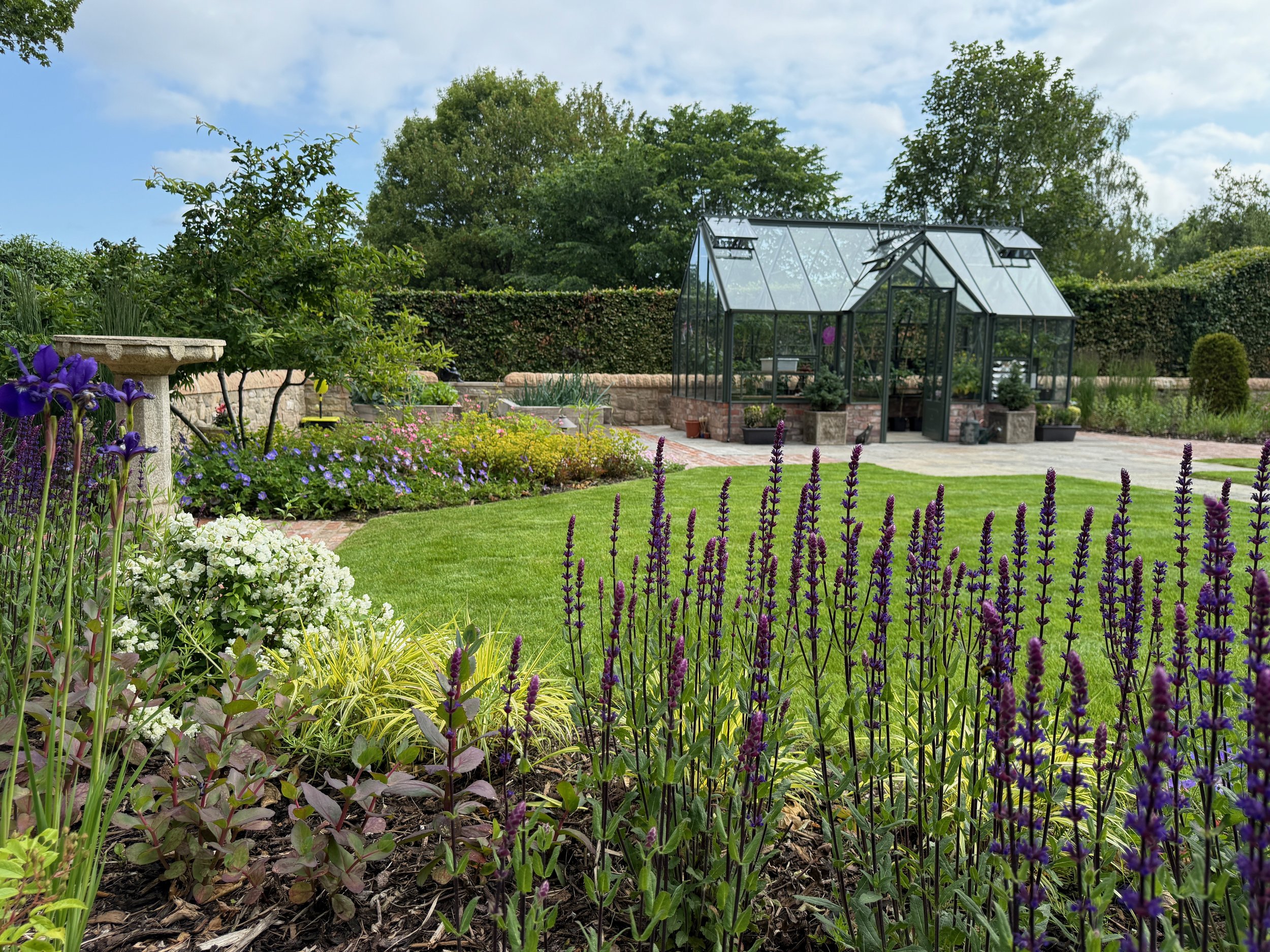 A bird bath and glasshouse