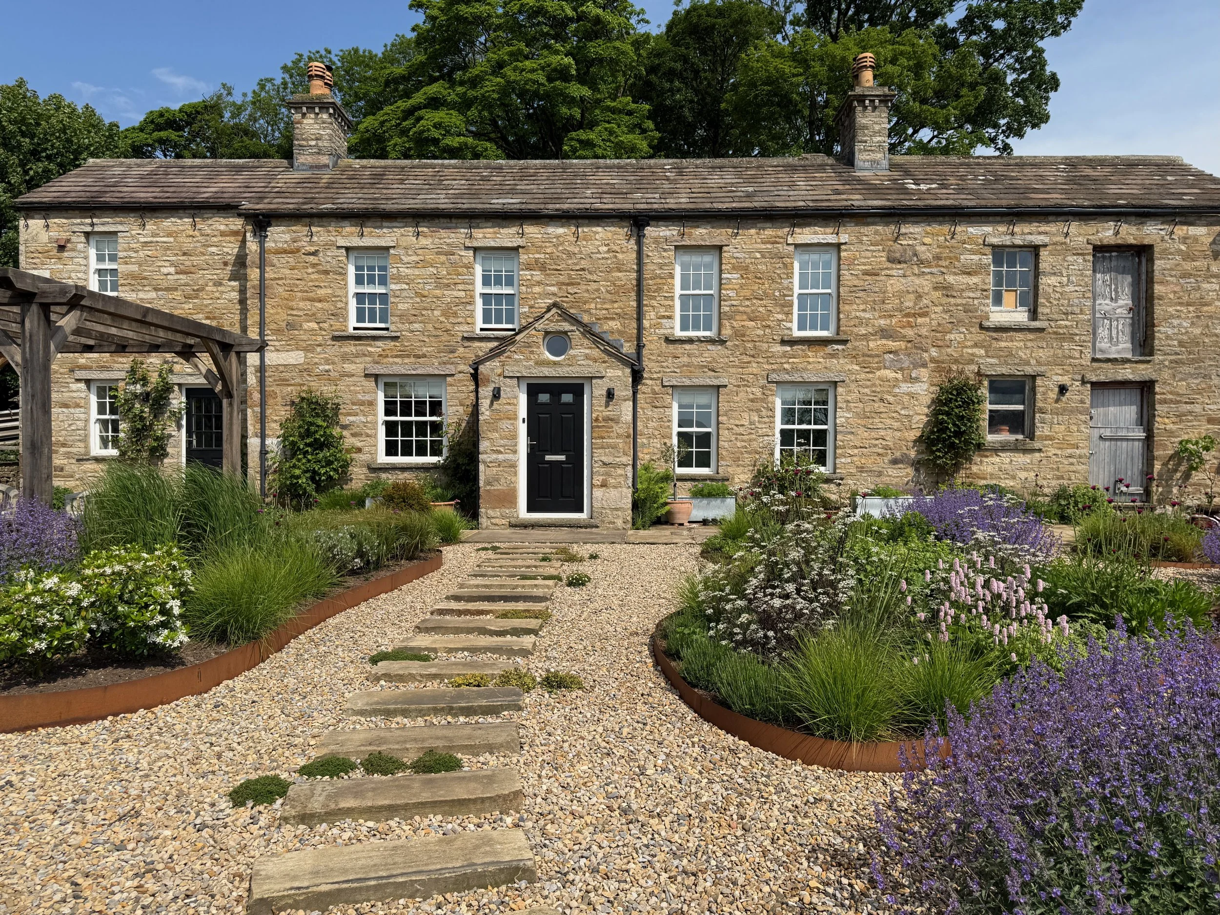 The front garden approach to the house through Corten raised beds