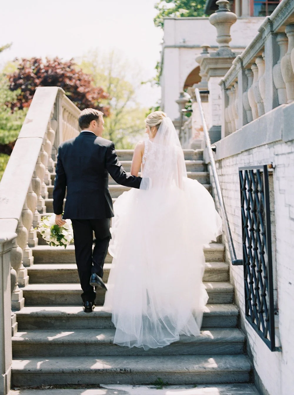  bride and groom walking up stairs at an italian villa at their luxury estate wedding 