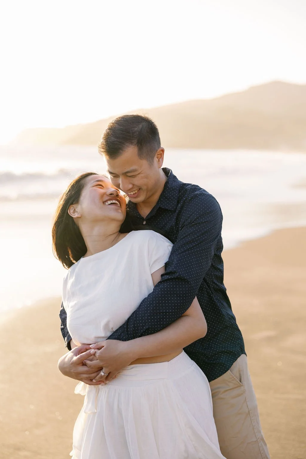  couple huge each other at their rodeo beach engagement session 