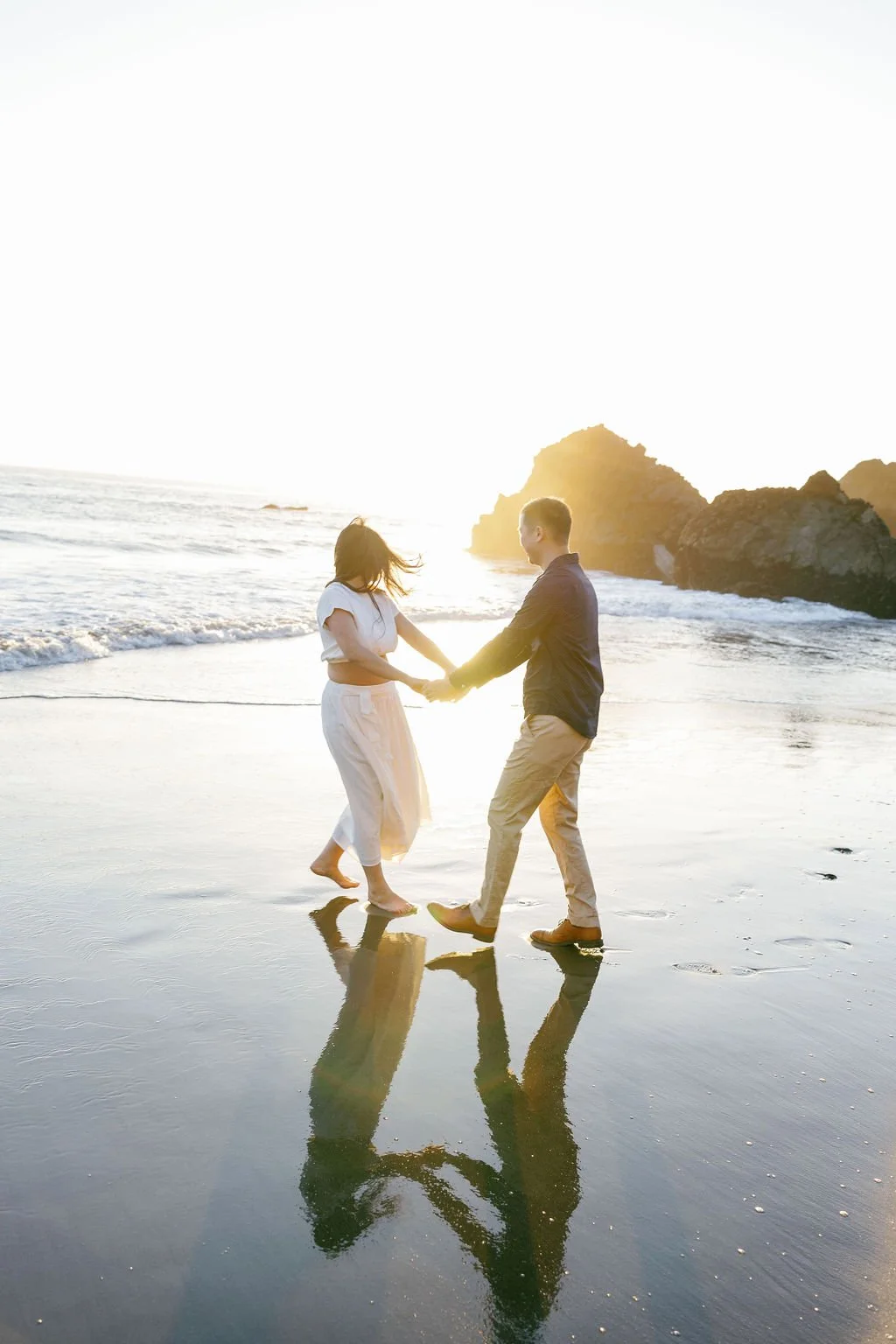 dancing on the beach at sunset