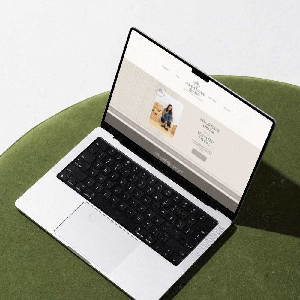 An open laptop with a black keyboard on a green cushion, displaying a website.