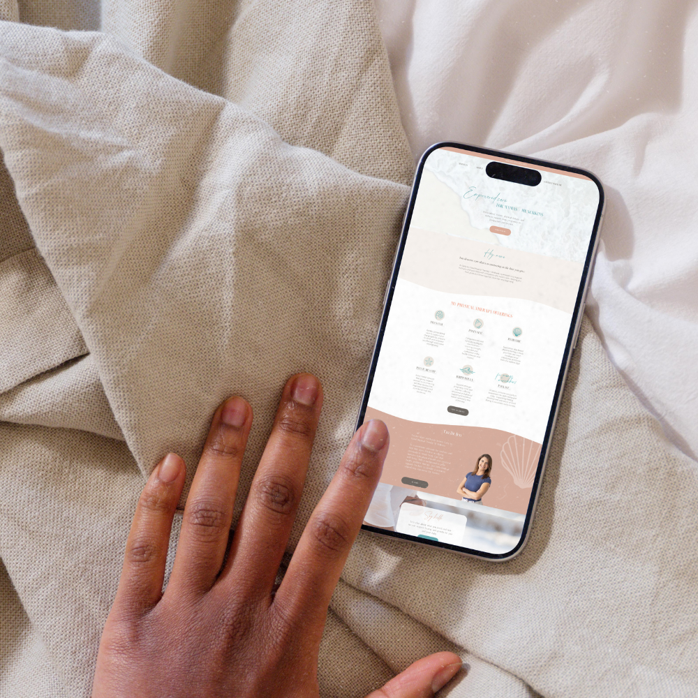 A person's hand interacting with a smartphone displaying a website on a light-colored fabric surface.