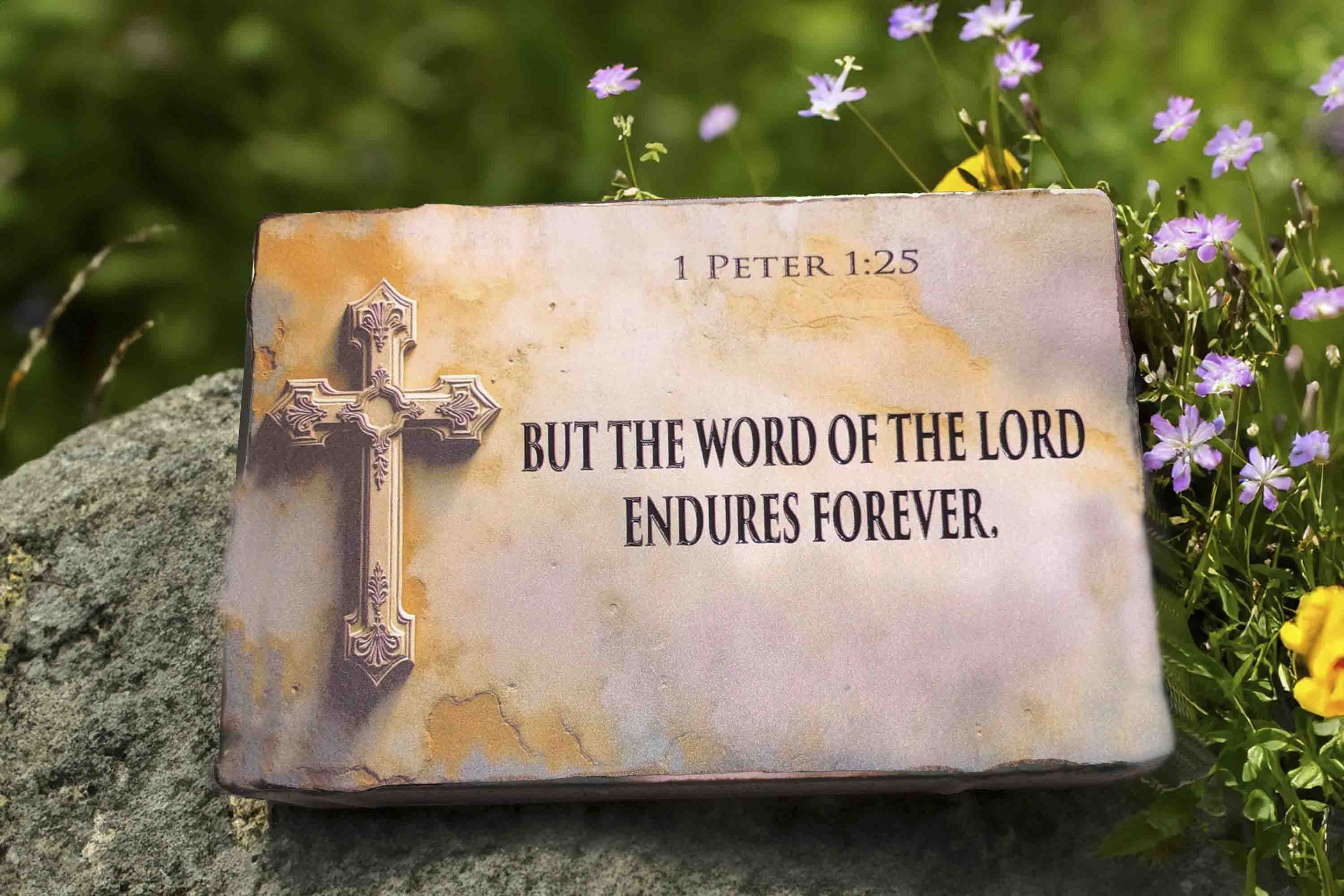 Christian memorial stone with cross and 1 Peter 1:25 scripture