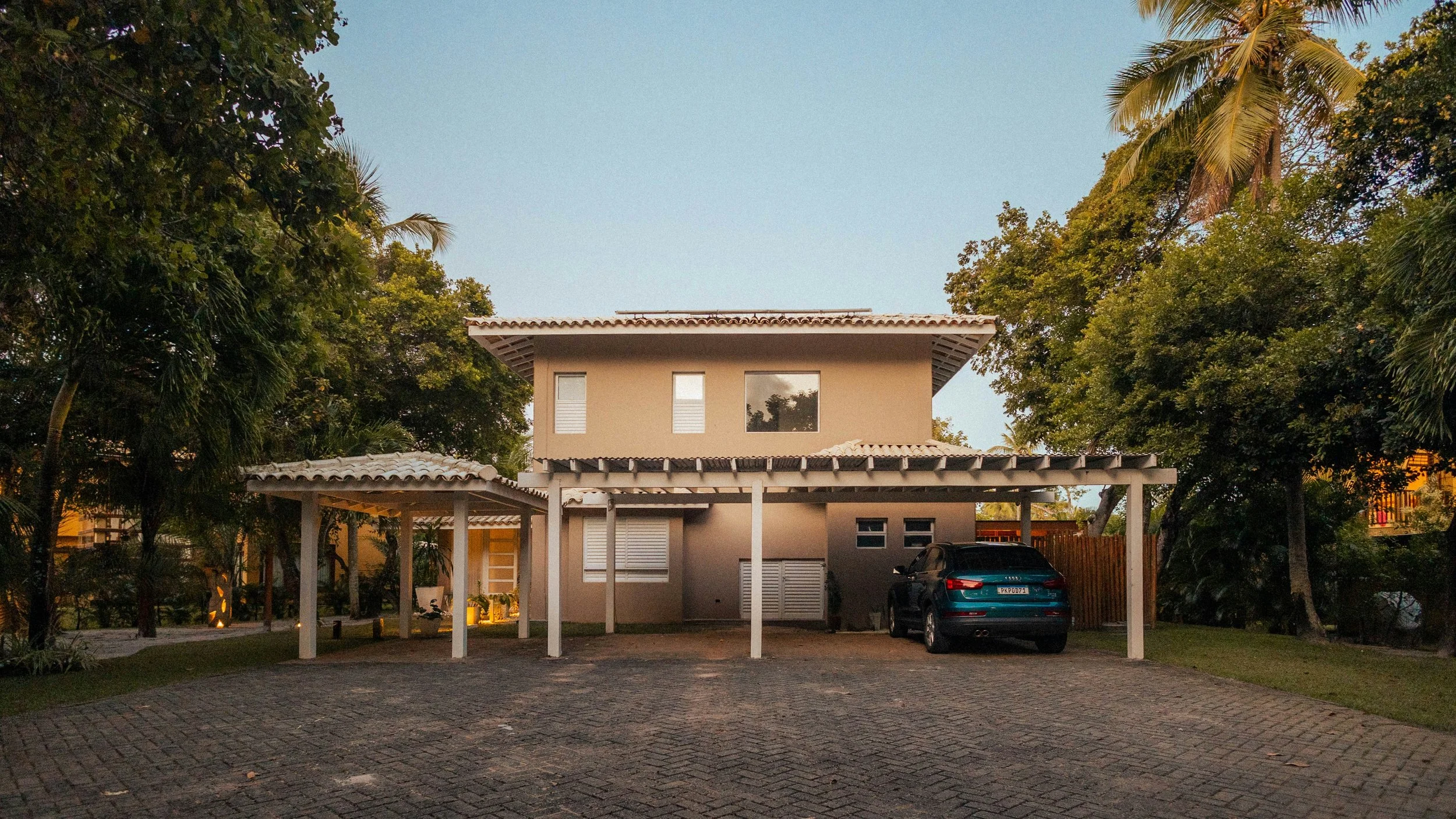 Two-story house with covered carport.